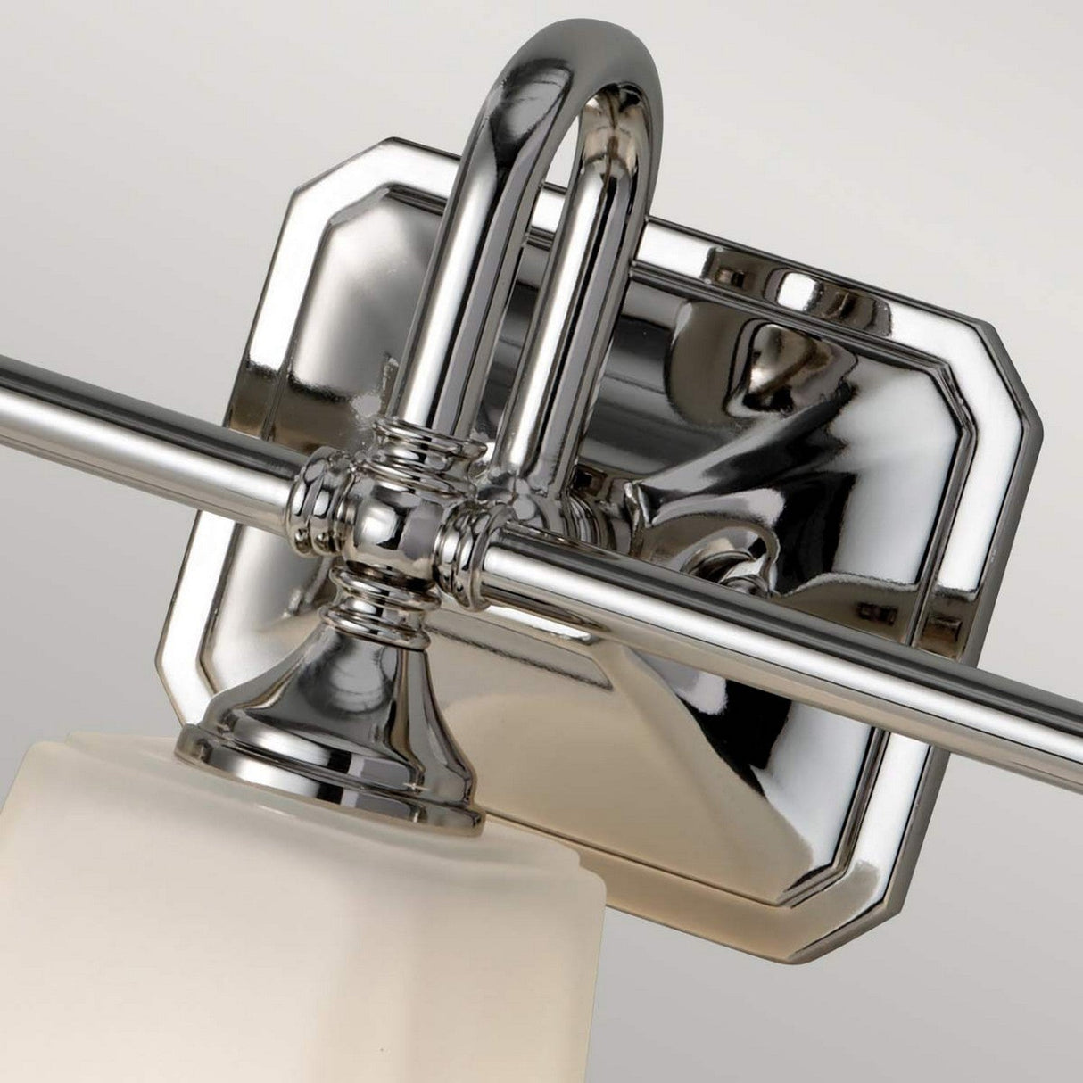 Here's a close-up of the Concord 3 Light Wall Light in a polished chrome finish. This fixture includes a square backplate and elegant curved arms that support opal-etched glass shades, creating a sleek and reflective design perfect for adding a modern touch to any space.