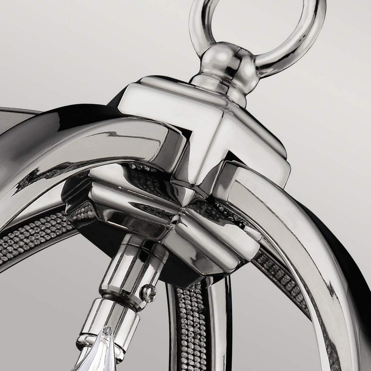 The Corinne 3 Light Small Chandelier in polished nickel highlights a contemporary pendant design with sleek curved arms and a decorative top ring. Its intricate details and glossy finish provide an elegant touch suitable for any space.