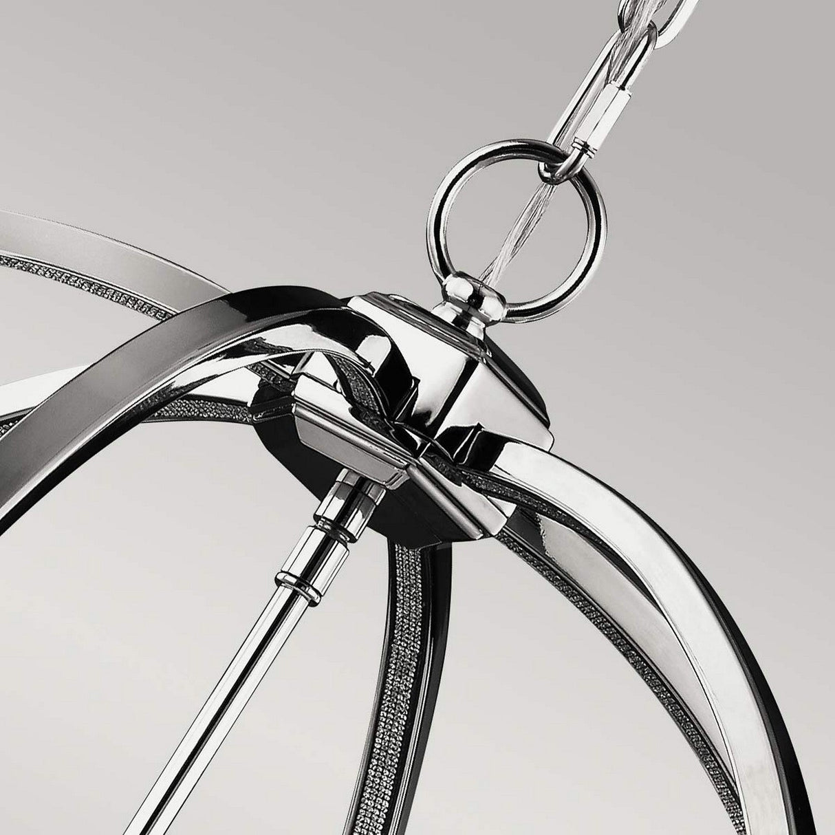 Close-up of the Corinne 6 Light Chandelier, showcasing its modern elegance with a polished nickel finish, elegant curved arms, and sleek metallic design. The chandelier is suspended by a chain, highlighting its contemporary style against a neutral background.