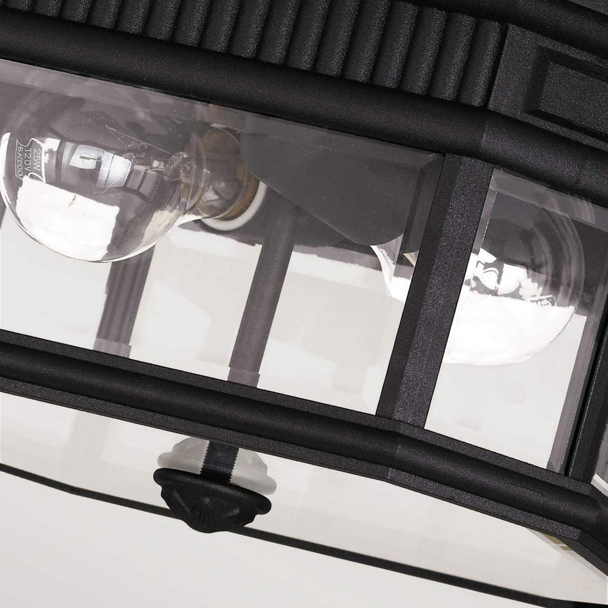 Close-up of the Cotswold Lane 2 Light Outdoor Flush in black, showcasing bevelled glass panes. Inside the rectangular casing are two visible light bulbs. This outdoor fixture features decorative ridges and a knob detail at the bottom, making it an elegant addition to any exterior space.