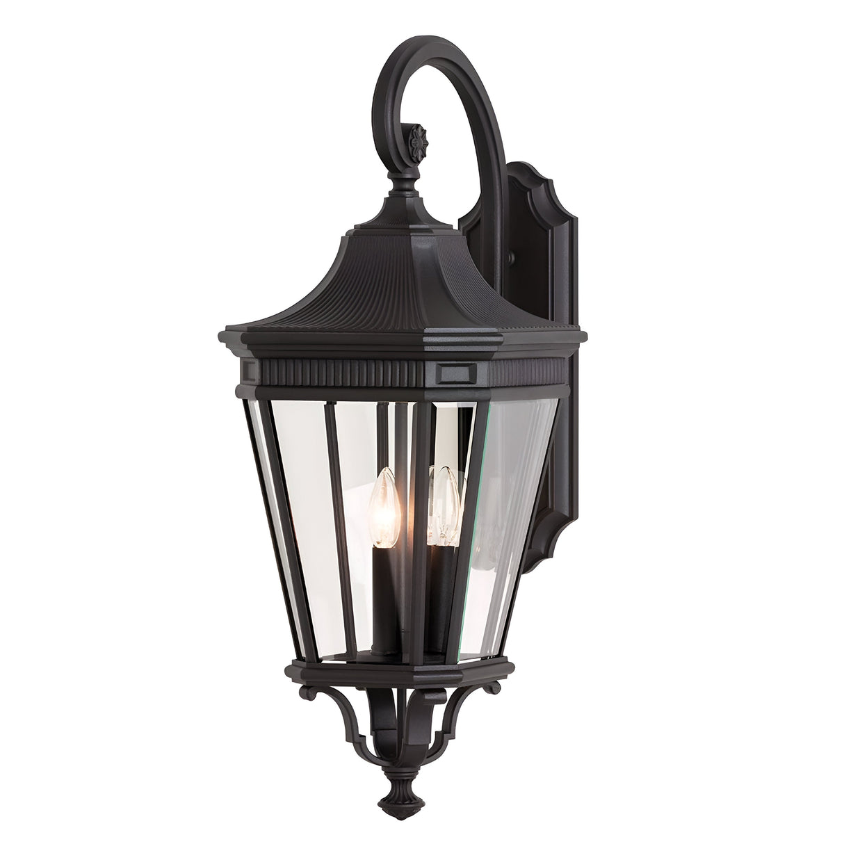 The Cotswold Lane 3 Light Outdoor Large Wall Lantern in black offers a classic design with clear glass panels and three candle-style bulbs. It features an elegant, curved top and a compact base, perfect for seamless mounting on surfaces to enhance your outdoor decor with sophistication.
