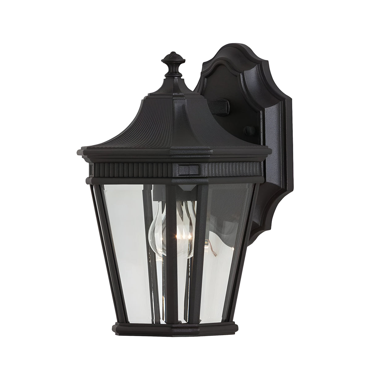With its traditional design, the Cotswold Lane 1 Light Outdoor Small Wall Lantern - Black showcases a black finish and clear glass panels that reveal a visible light bulb inside, all elegantly mounted on a decorative metal bracket.