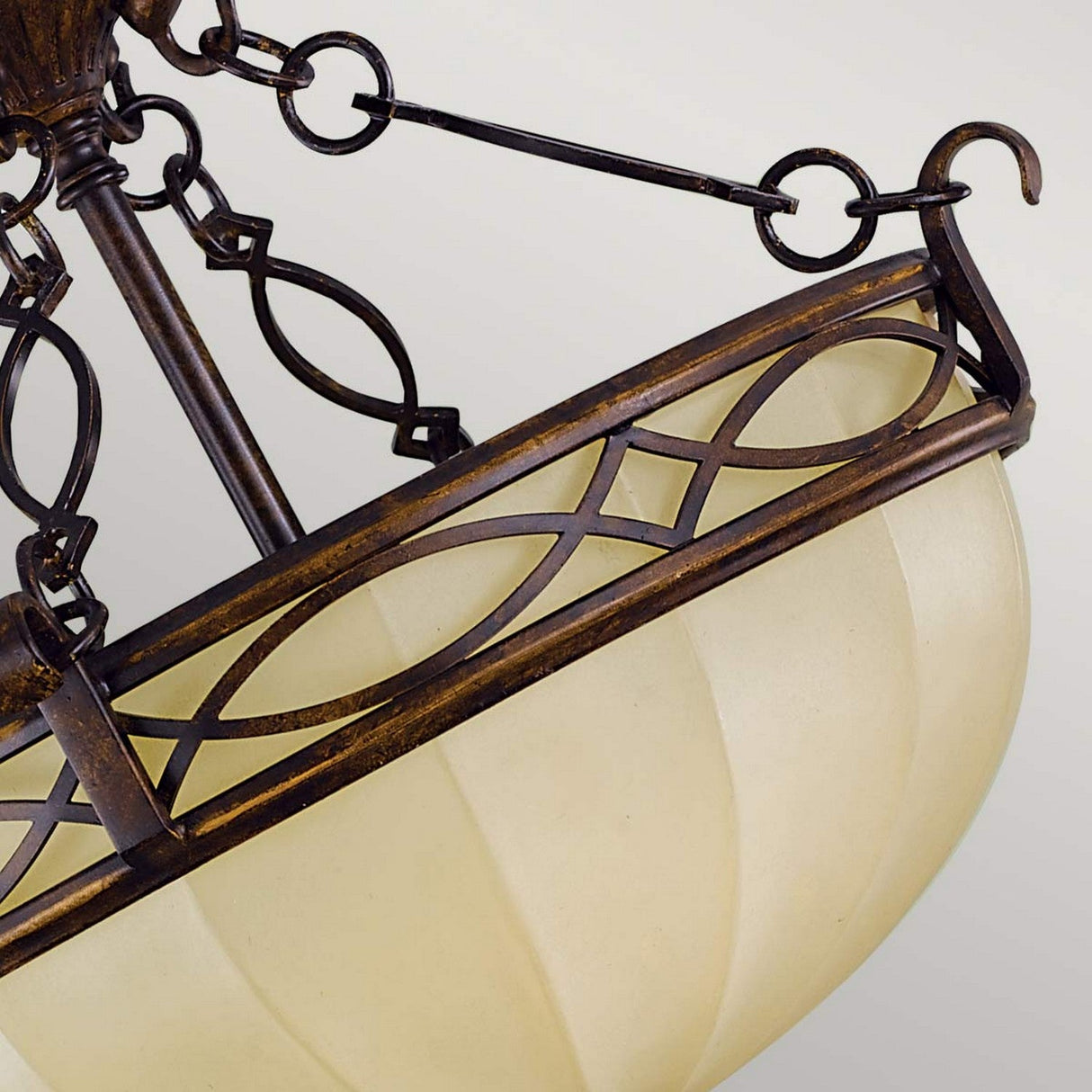 Close-up of the Drawing-3 Room 2 Light Semi Flush - Walnut exuding Edwardian elegance, showcasing a bronze finish with intricate metalwork. The fixture boasts a cream-colored, downward-facing frosted glass bowl, adorned with an elegant interlocking oval and diamond pattern that incorporates a hint of walnut tone.