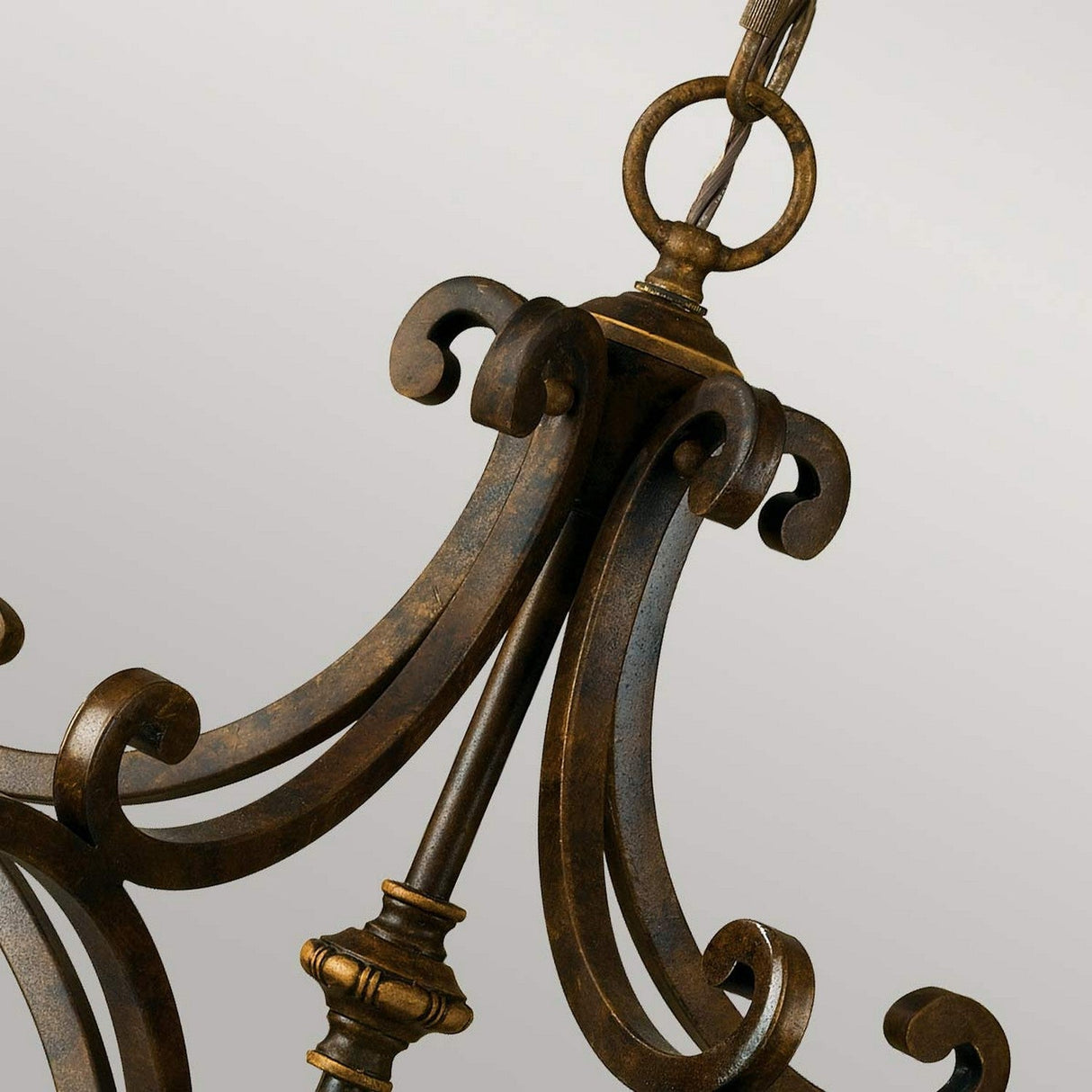Close-up of a Drawing Room 5 Light Chandelier in walnut finish, featuring ornate Edwardian charm with intricate, curved designs against a neutral background. The chandelier exudes vintage appeal through its elegant scrollwork and detailed craftsmanship.