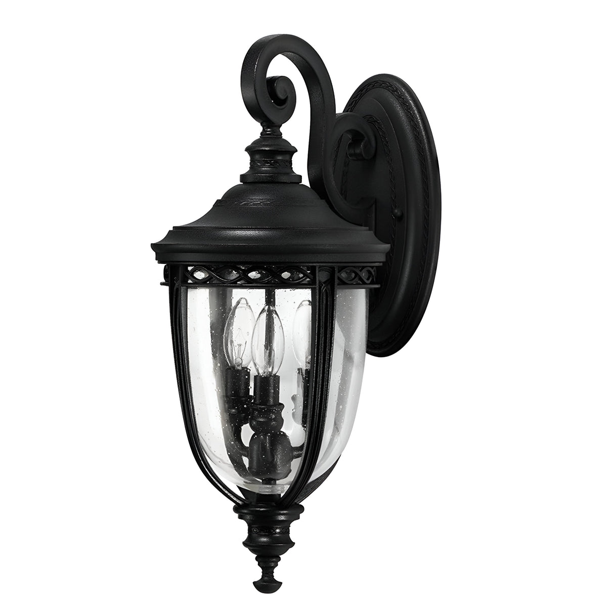 The English Bridle 3 Light Outdoor Medium Wall Lantern in black boasts an elegant design with ornate detailing and features clear seeded glass panels surrounding three candle-like bulbs. Mounted on a circular wall plate, this fixture adds a classic touch to any exterior setting.