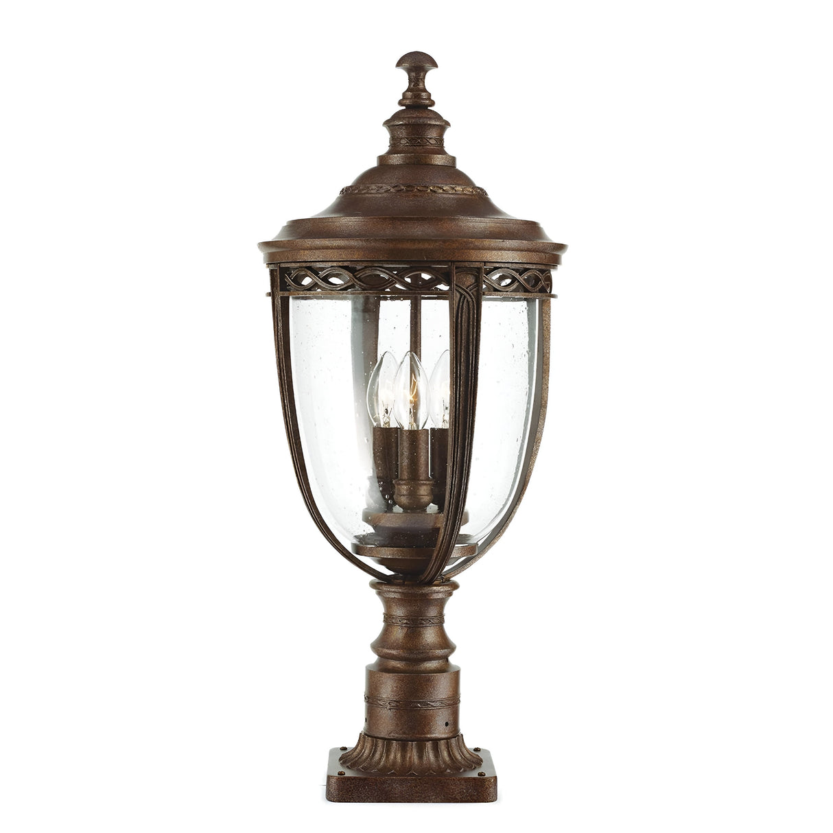 The English Bridle 3 Light Outdoor Large Pedestal - Bronze embodies vintage charm with its bronze finish and clear glass panels. Elaborate detailing on the frame adds to its classic allure, while a candle-like bulb inside enhances the nostalgic aesthetic.