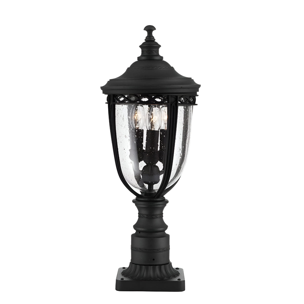 The English Bridle 3 Light Outdoor Medium Pedestal - Black exudes a vintage style with its elegant black finish and clear seeded glass casing. The intricate details harmonize beautifully with the two visible light bulbs inside, enhancing the charm of any outdoor space.