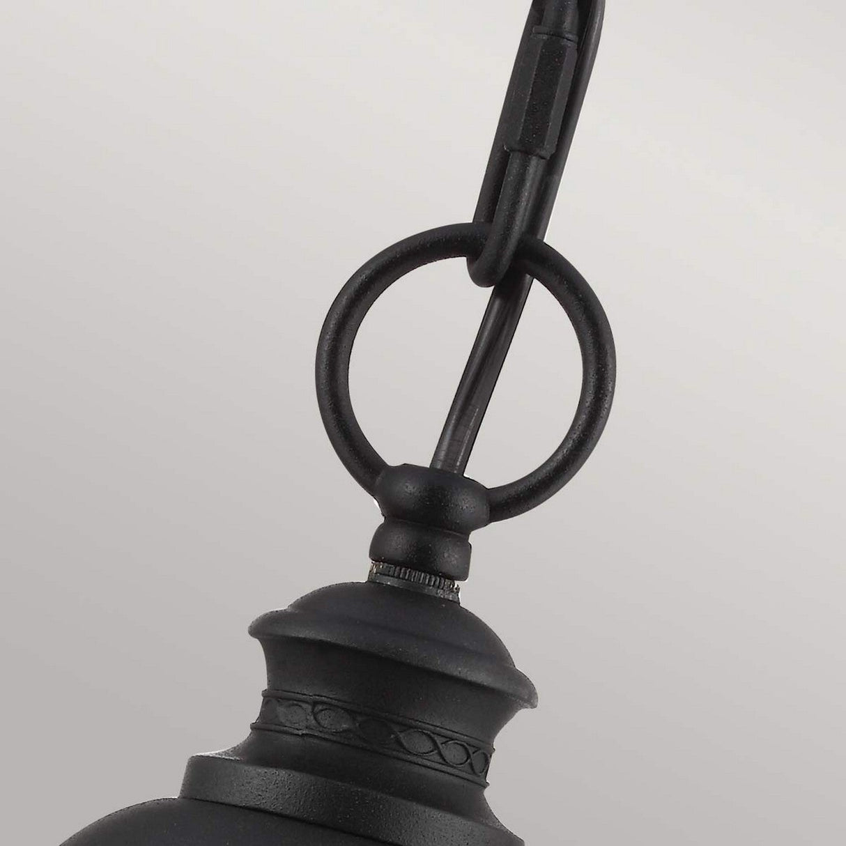 Close-up of the English Bridle 3 Light Outdoor Large Chain Lantern in black, showcasing its clear seeded glass and decorative design with a circular hook against a light, neutral grey background.