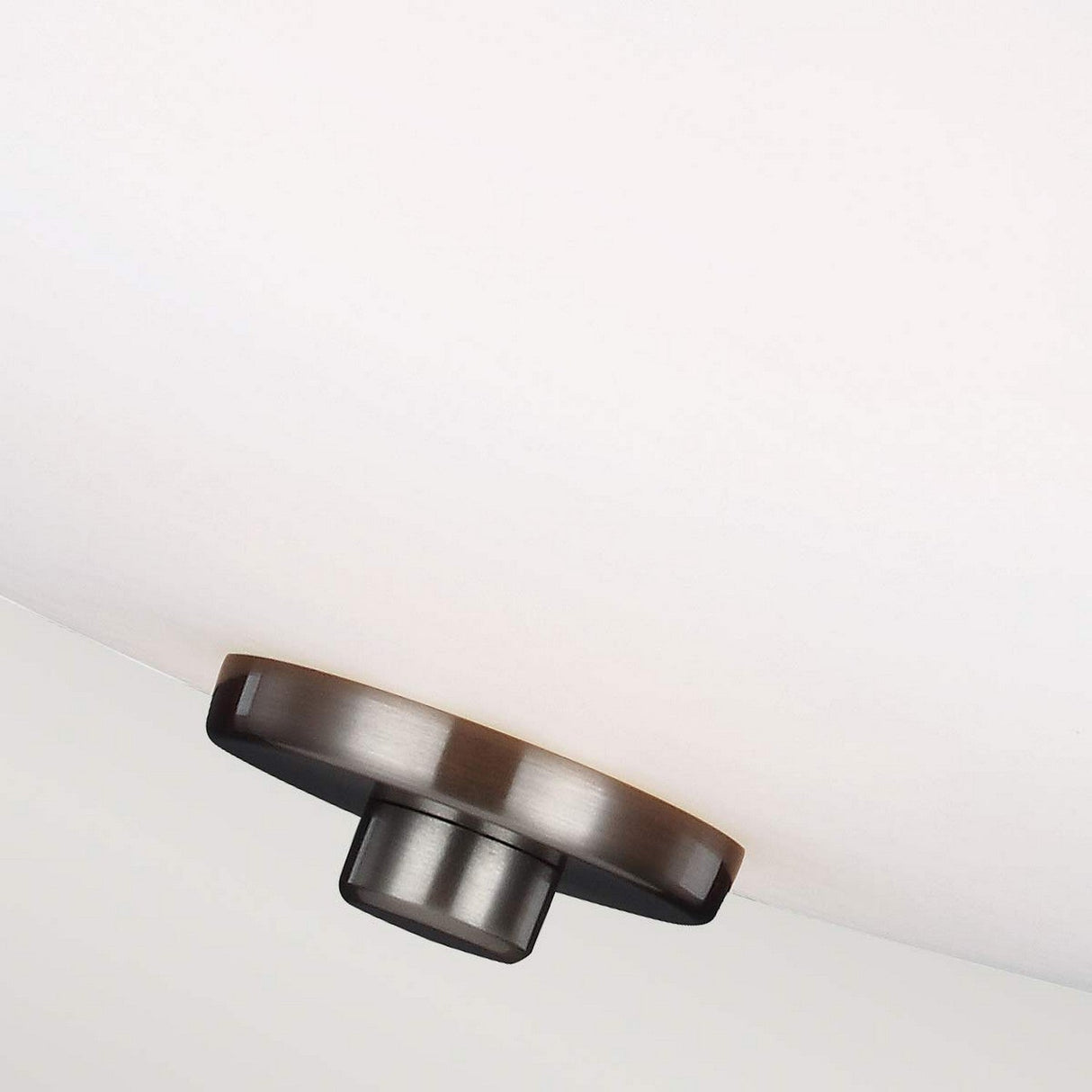 Close-up of the Evington 2 Light Semi Flush in satin nickel, showcasing a contemporary ceiling light with a circular mount connected to a large, white dome-shaped shade. The minimalistic design adds a sleek and modern touch.