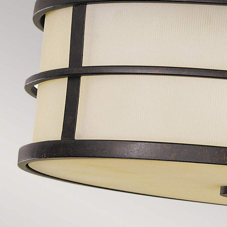 A detailed view of the Fusion 3 Light Flush - Grecian Bronze ceiling light fixture showcases its circular metal frame with a grid-like pattern of horizontal and vertical lines. The cream-colored panels complement the Grecian Bronze finish, creating an ambient atmosphere even when the light is turned off, set against a simple backdrop.