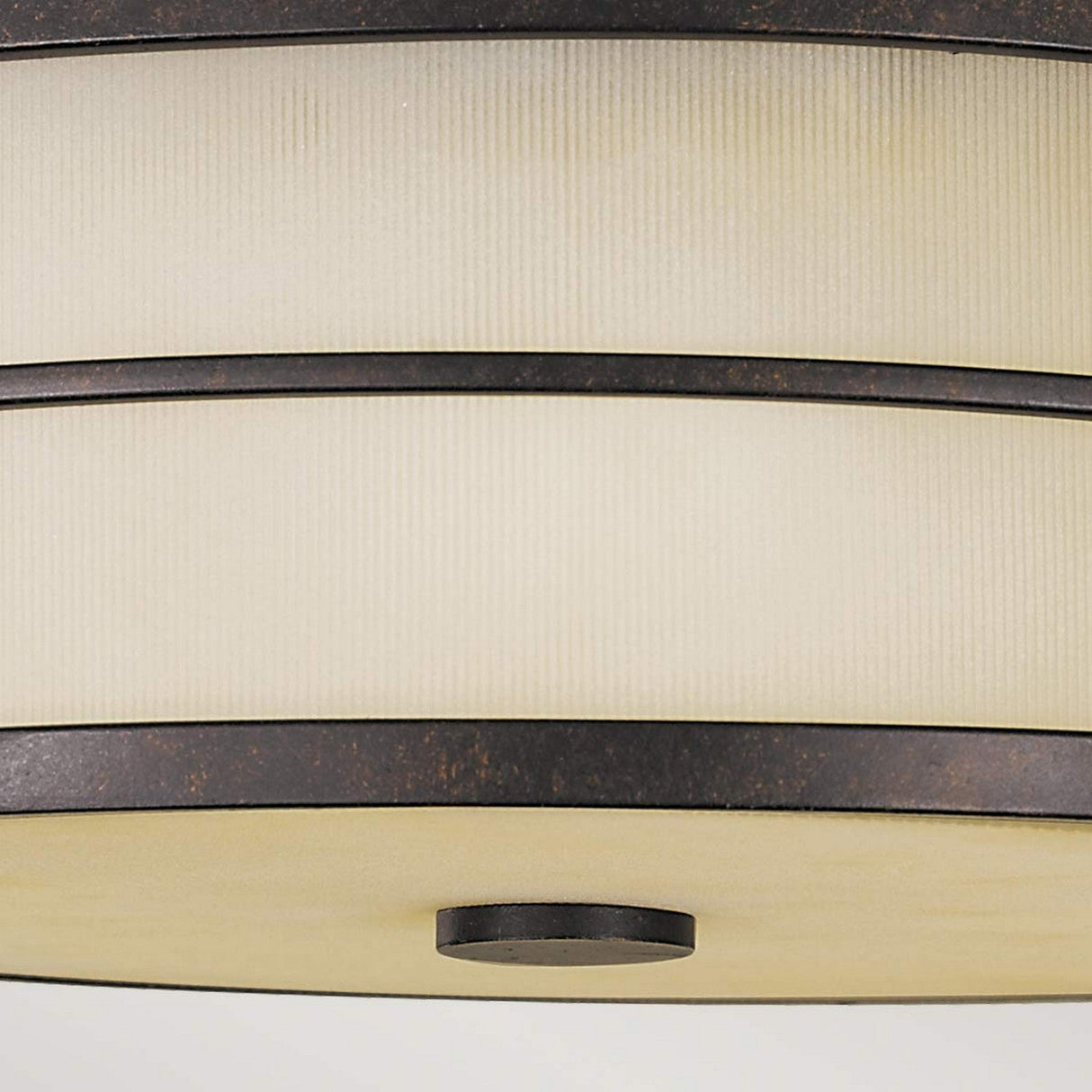 The Fusion 3 Light Flush - Grecian Bronze ceiling fixture features a sleek and minimalist design with a frosted glass shade and Grecian Bronze metal accent bands, creating an ambient atmosphere. Its round metal detail at the bottom center adds a touch of elegance.