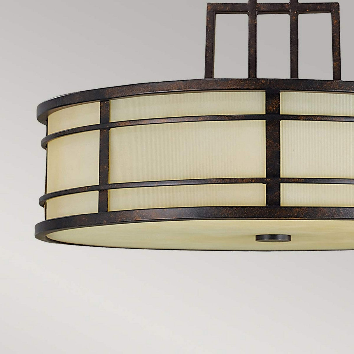 A close-up of the Fusion 3 Light Chandelier - Grecian Bronze showcases its modern round design with an iron frame and frosted glass shade, accented by horizontal and vertical metal bars, set against a plain gray background.