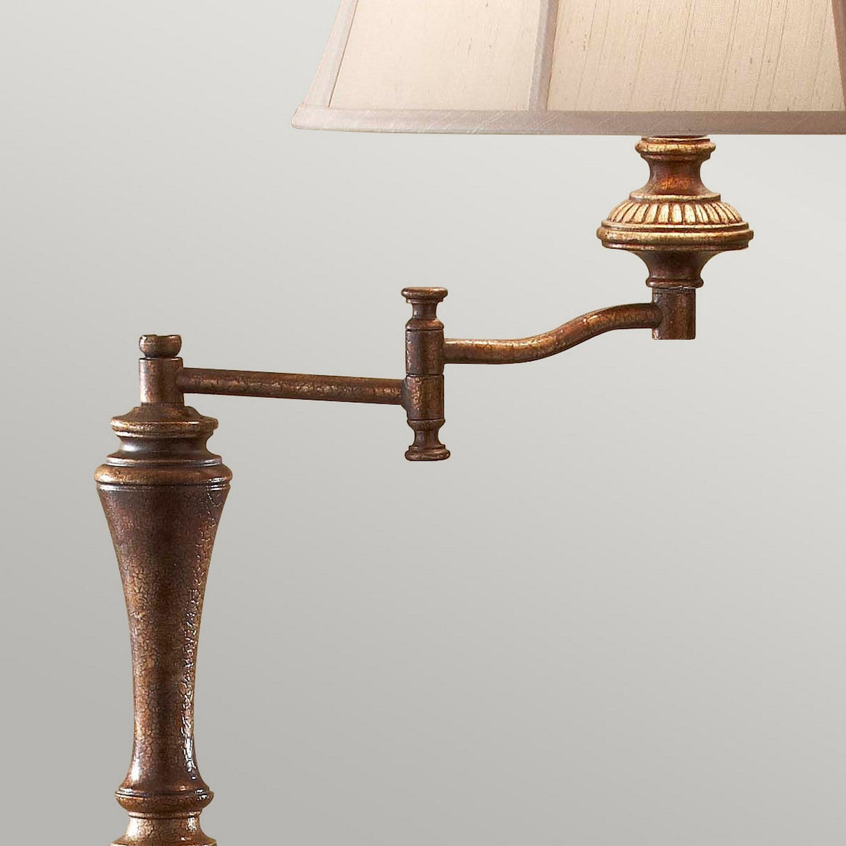 The Gibson 1 Light Floor Lamp in dark brown features a vintage-style bronze design with an adjustable arm and a desert linen fabric shade in cream, perfect for complementing a neutral backdrop.