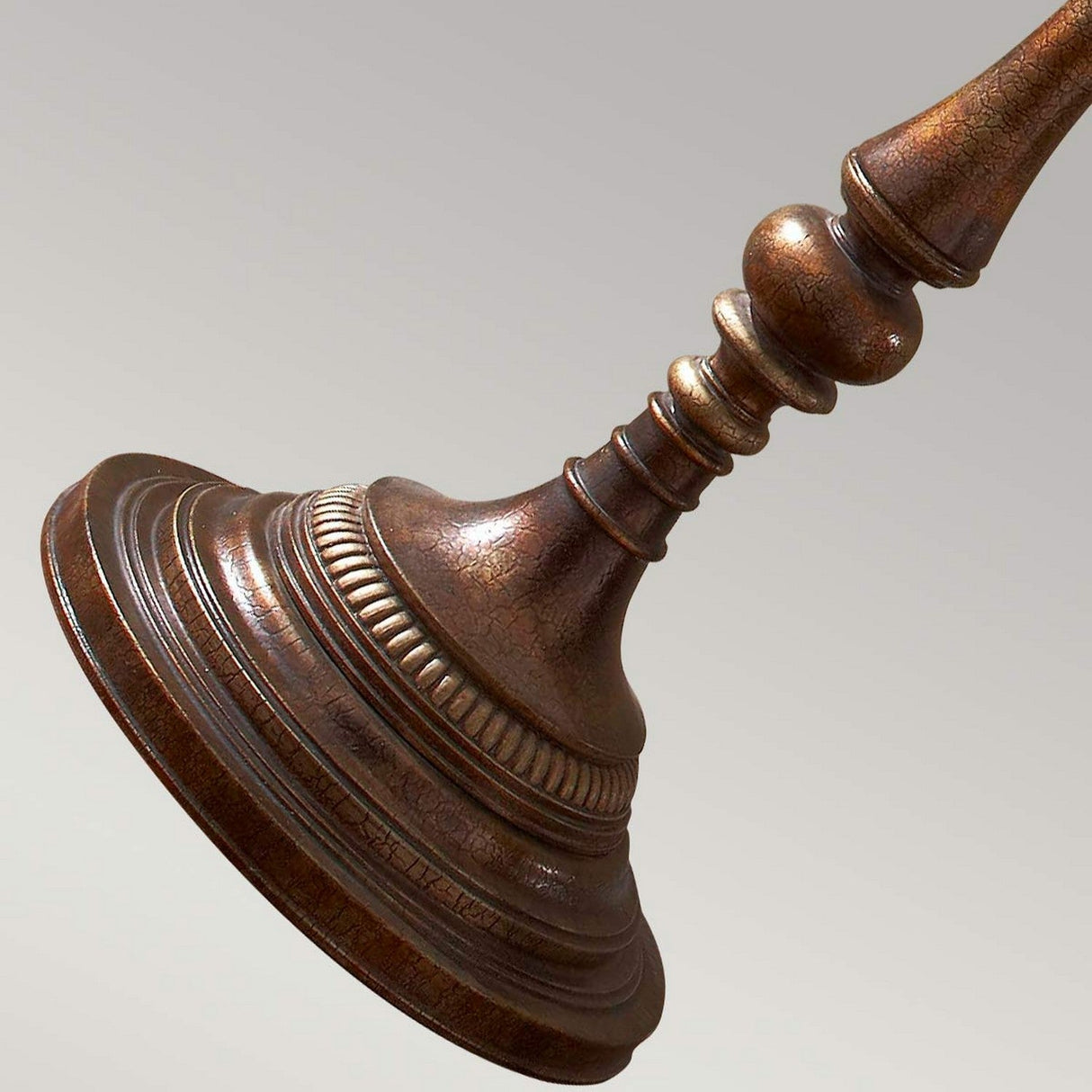 Close-up of the base of the Gibson 1 Light Floor Lamp in a dark brown finish, showcasing its vintage-style ornate detailing. The background is a plain, neutral gray.