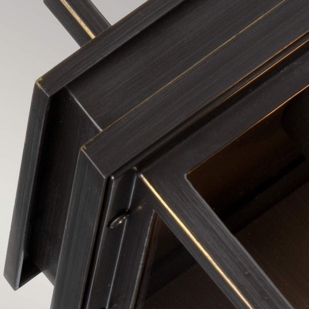 Close-up of the Glenview 1 Light Outdoor Medium Wall Lantern in antique bronze, showcasing its geometric metal structure with a modern design reminiscent of Prairie-style architecture. The lantern features overlapping rectangular shapes and clean lines, set against a light background to highlight its sleek and industrial appearance.