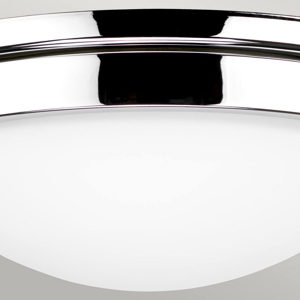 Detailed look at the Gravity 2 Light Flush - Polished Chrome, a contemporary ceiling light featuring a smooth white frosted glass dome and sleek polished chrome trim, offering a minimalist design for modern lighting aesthetics.