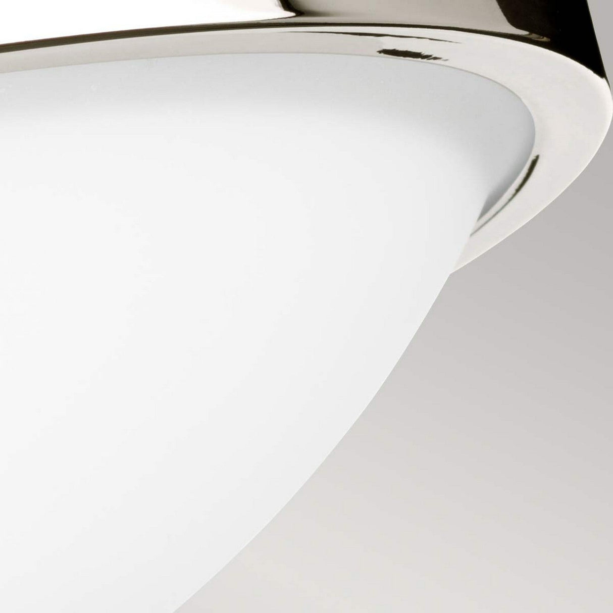 Close-up of the Gravity 2 Light Flush, highlighting its sleek, curved metal rim in polished nickel and white glass shade, set against a neutral background.