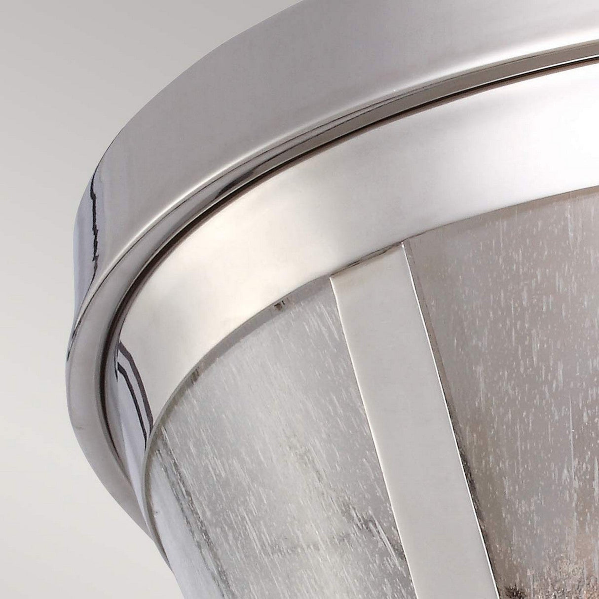 Close-up of the Harrow 2 Light Flush - Polished Nickel ceiling light fixture. The polished nickel finish enhances the textured seeded glass panels, highlighting contemporary design elements against a neutral background.