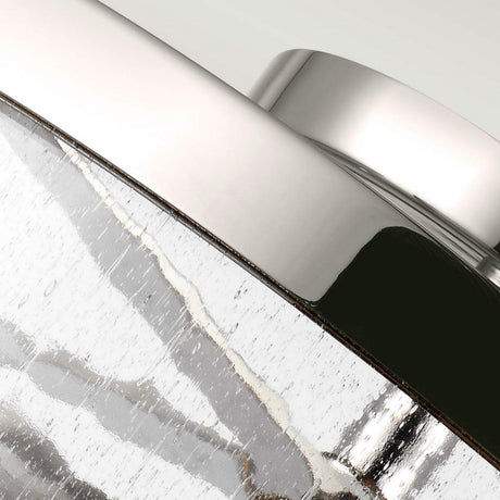 Close-up of the Harrow 2 Light Semi Flush in polished nickel, showcasing its rounded edge and textured, reflective areas that contribute to its industrial look. The light accentuates the smooth finish and irregular patterns on its surface.