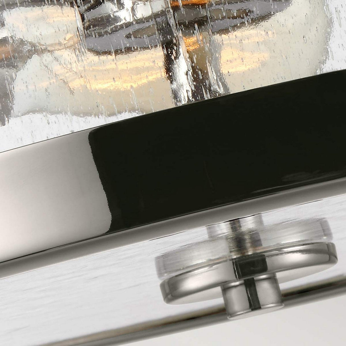 Close-up of the Harrow 2 Light Semi Flush in polished nickel, featuring a clear seeded glass shade. The textured surface and single bolt elegantly reflect light, with visible parts of the bulbs inside.