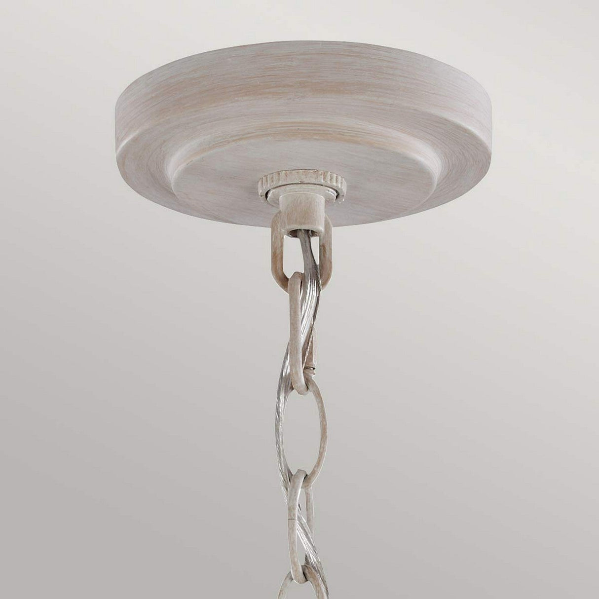 The Hartsville 5 Light Chandelier in Chalk Washed/Beachwood features a round base with a decorative chain loop for hanging. Its farmhouse-inspired design exudes rustic charm, making it perfect for versatile placement options in any space.