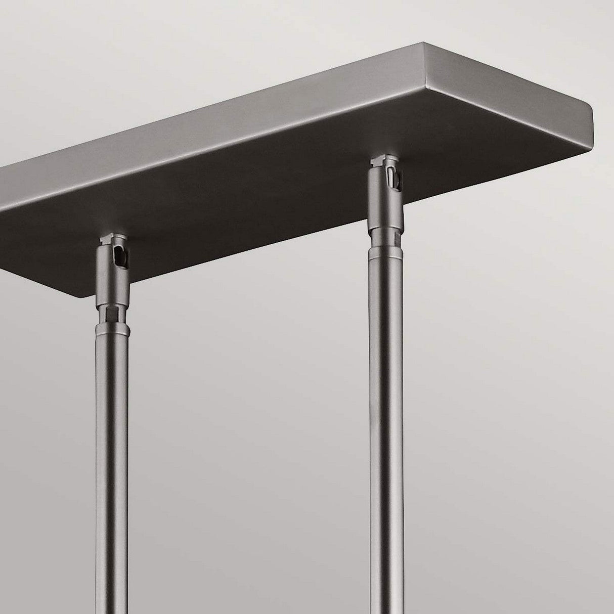 The Hobson 3 Light Island Light in Satin Nickel boasts a minimalist design with two cylindrical rods supporting a rectangular panel, seamlessly creating a sleek and modern aesthetic with an industrial touch.