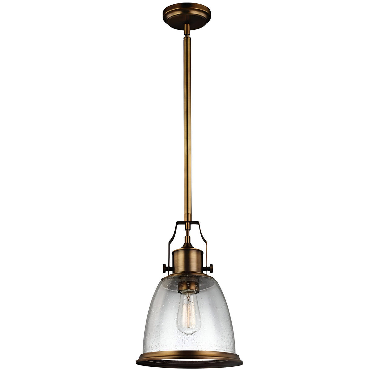 The Hobson 1 Light Medium Pendant - Aged Brass showcases an aged brass finish and a clear glass bell-shaped shade. It suspends from a lengthy brass rod, complemented by a visible Edison bulb that accentuates its industrial charm.
