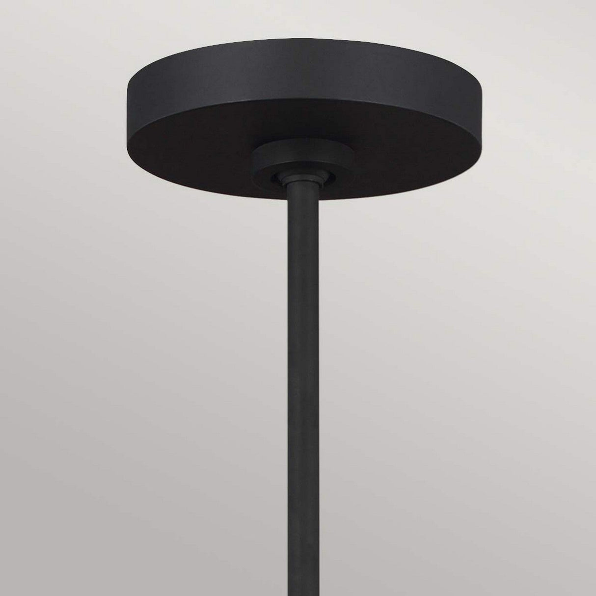 The Jax 10 Light Chandelier in Midnight Black, featuring a circular ceiling canopy with an attached rod, hangs downward against a plain gray background, embodying the essence of modern chandelier design.