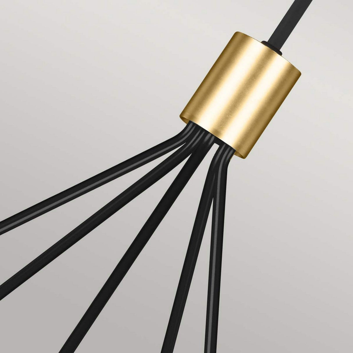Close-up of the Joan 5 Light Chandelier - Midnight Black/Burnished Brass, showcasing its burnished brass cylindrical connector and five outward-spreading midnight black rods, set against a light gray background.