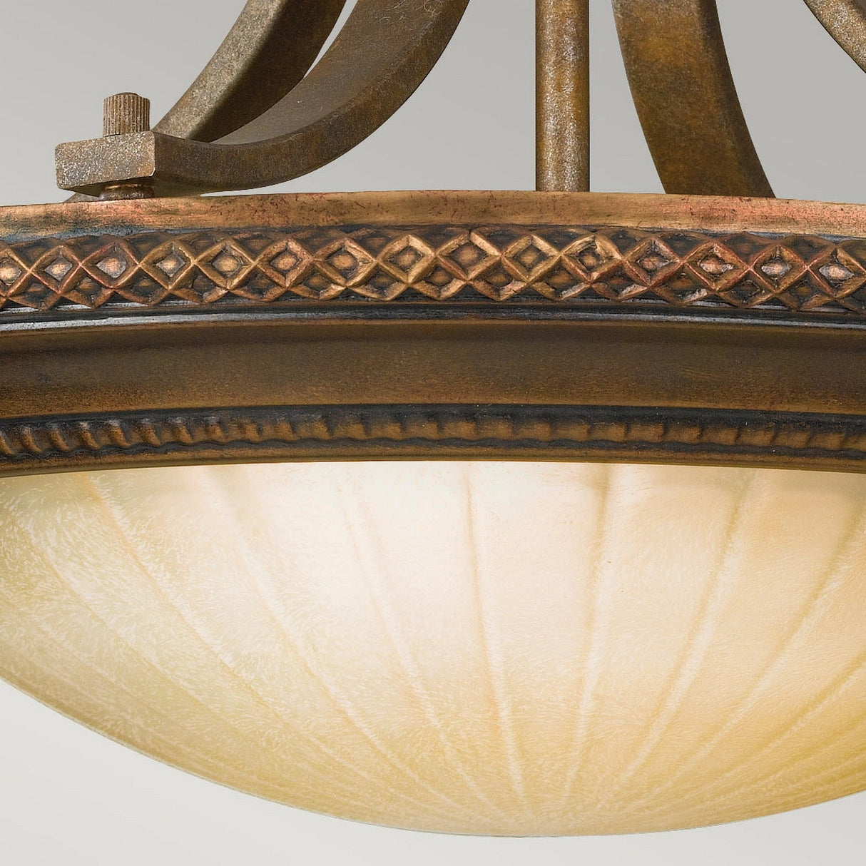 Close-up of an ornate Kelham Hall 2 Light Semi Flush fixture with a frosted, ribbed glass dome. The rim showcases a detailed, diamond-patterned metal design in British Bronze, enhancing its vintage appearance.