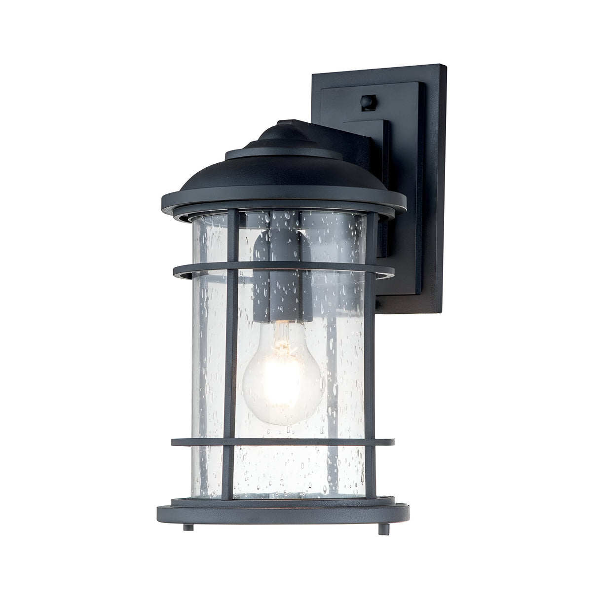 The Lighthouse 1 Light Outdoor Medium Wall Lantern in Textured Black boasts a textured black metal frame and cylindrical clear glass around an illuminated bulb. Its raindrop-like glass provides a nautical design accent to any setting.
