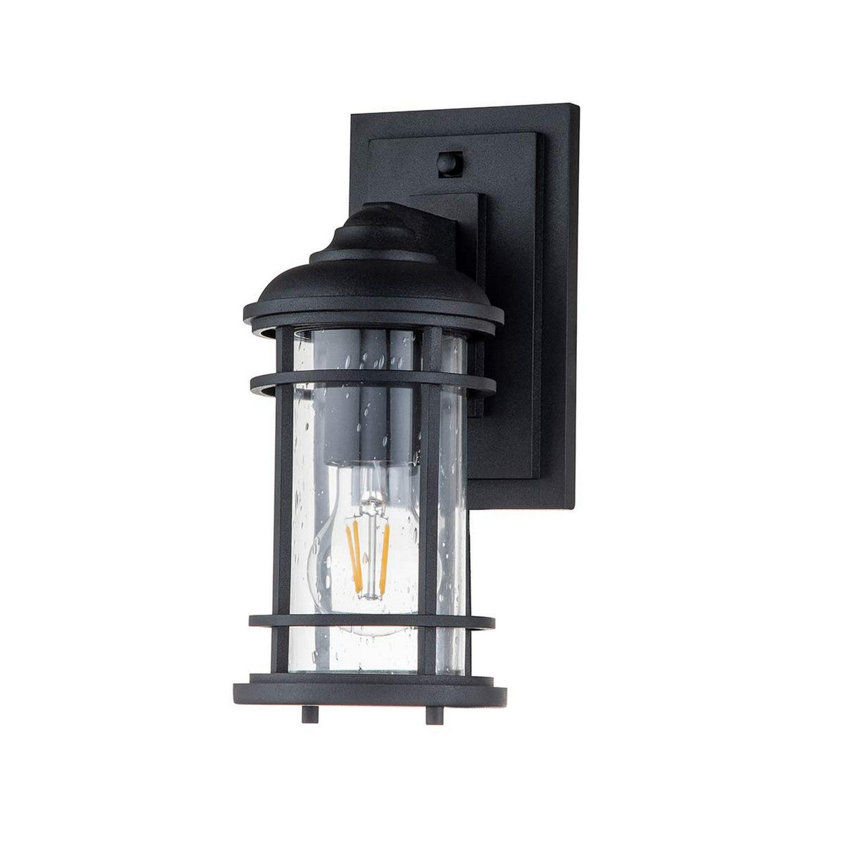 The Lighthouse 1 Light Outdoor Small Wall Lantern in textured black features a rectangular base and a cylindrical glass cover that reveals a visible bulb inside. Its bubbled glass design offers a nautical-inspired touch, seamlessly blending classic and modern aesthetics for this outdoor wall fixture.