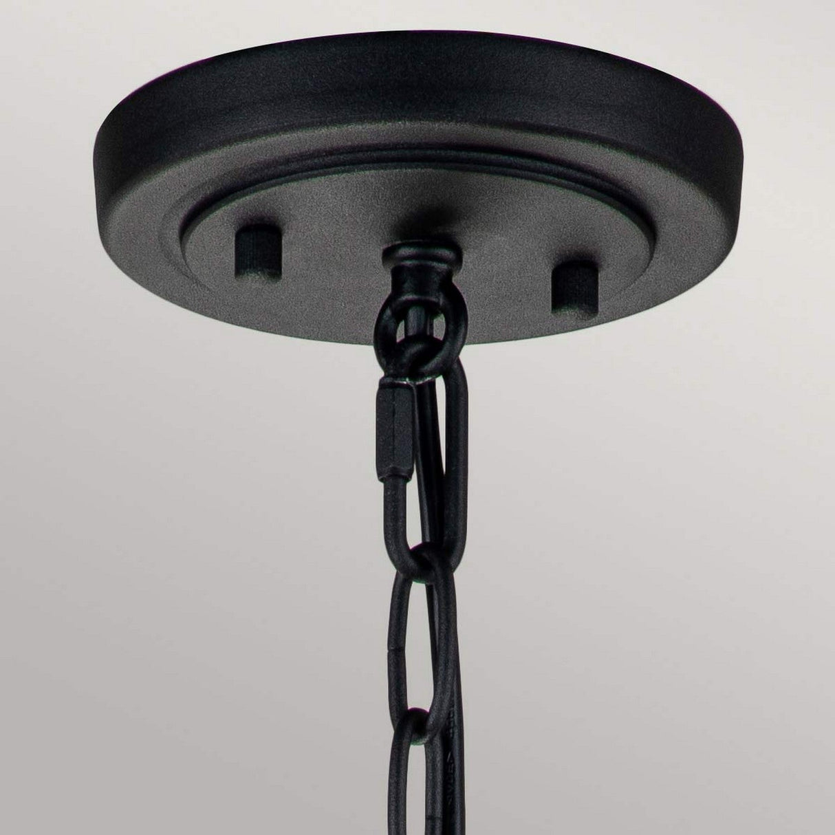 The image highlights the Lighthouse 1 Light Outdoor Small Chain Lantern in a textured black finish, featuring a black metal canopy. The chain is stylishly looped and connected to the clear seeded glass fixture, perfect for hanging lights. It is set against a gentle, neutral background that evokes the feel of nautical outdoor lanterns.