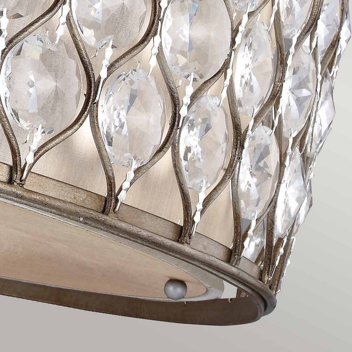Close-up of the Lucia 6 Light Flush in burnished silver, showcasing its elegant metal frame adorned with exquisite Bauhinia crystals. The crystals reflect light beautifully, creating a shimmering effect against a softly blurred background.