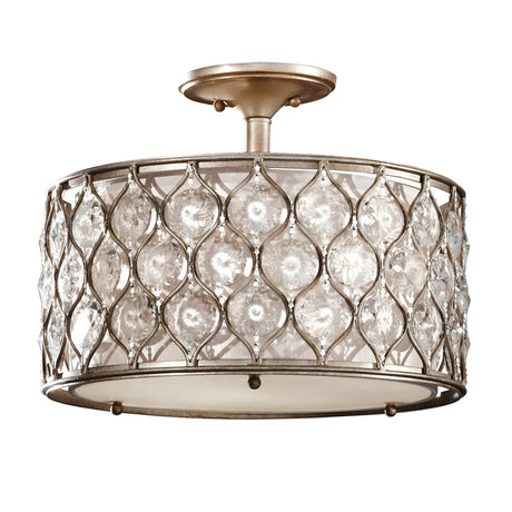 The Lucia 1 Light Semi Flush features a drum-shaped frame with intricate metalwork and inset Bauhinia crystals. It has a burnished silver finish, elegantly mounted to the ceiling for a luxurious and timeless appearance.
