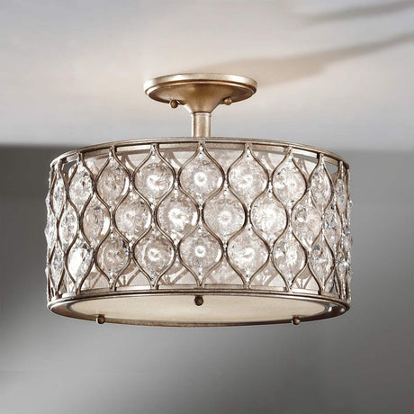 The Lucia 1 Light Semi Flush fixture, with its burnished silver metal frame and Bauhinia crystals, casts a warm and elegant glow. The design is enhanced by diamond-shaped crystal inserts, adding a touch of sophistication to any room.
