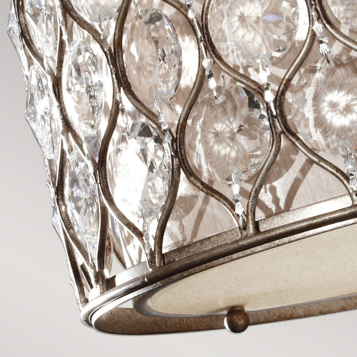 Close-up of the Lucia 1 Light Semi Flush - Burnished Silver, featuring an elegant metal lattice design. The lattice is adorned with Bauhinia crystals that catch the light, creating a shimmering effect. The burnished silver finish of the fixture enhances its sophisticated appearance.