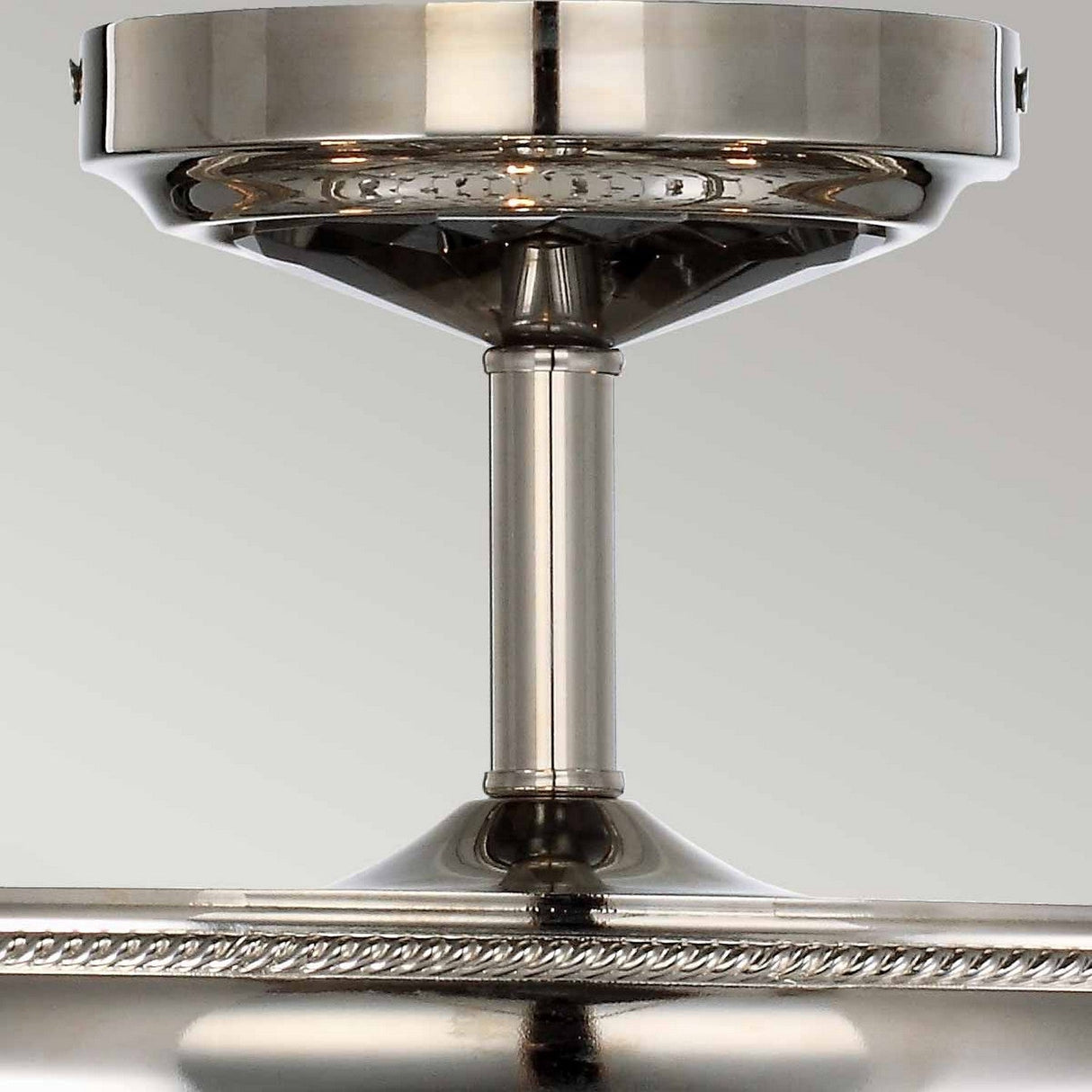 Close-up of the Malia 3 Light Semi Flush - Polished Nickel, featuring a cylindrical rod connecting the ceiling mount to the base, with decorative edge detail and smoked crystal glass accents.