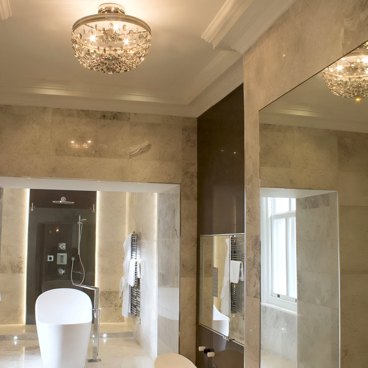 In the luxurious bathroom, marble walls, a freestanding bathtub, and a large mirror reflecting a window create an elegant atmosphere. Enhancing this elegance is the modern Malia 3 Light Semi Flush in polished nickel with smoked crystal glass mounted on the ceiling. Towels are neatly arranged on a heated rack for added convenience.