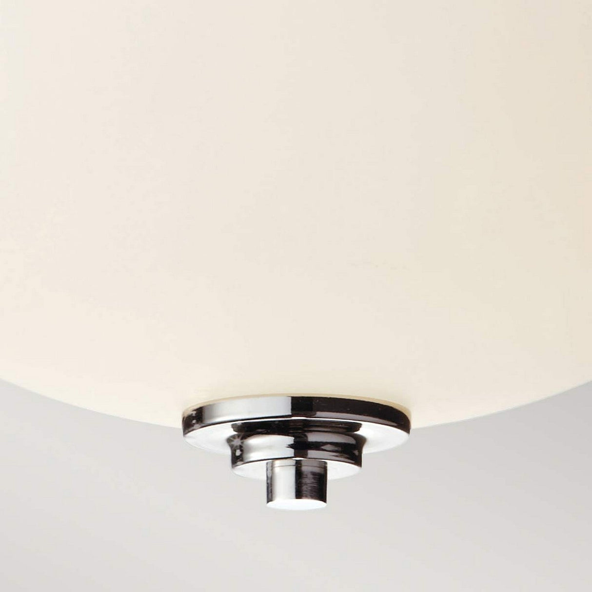 A close-up of the Malibu 2 Light Flush - Polished Chrome showcases its modern design, featuring a round, smooth dome made of opal-etched glass with a polished chrome and black base. The light is off, highlighting its minimalist style against a neutral background.