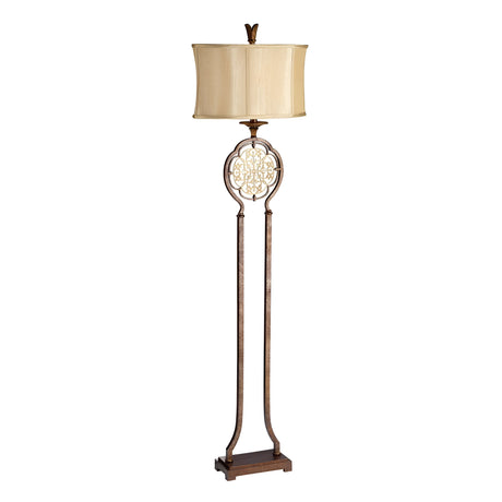 The Marcella 1 Light Floor Lamp in bronze showcases a decorative metal frame with a beige, slightly curved lampshade. Its design incorporates filigree details and a sturdy base, seamlessly blending elegance with vintage charm.