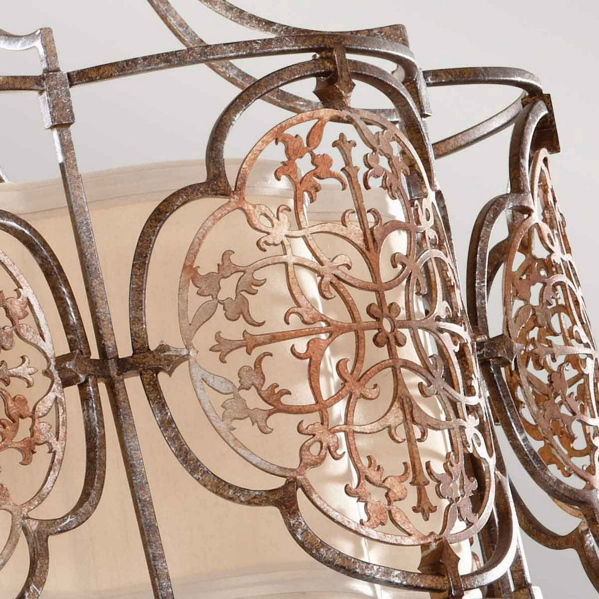 A close-up of the Marcella 3 Light Semi Flush in bronze showcases its ornate, metal lantern design, exuding exotic elegance with intricate floral and geometric patterns. The weathered bronze finish adds character and a light fabric visible inside hints at its function as a semi-flush lampshade.
