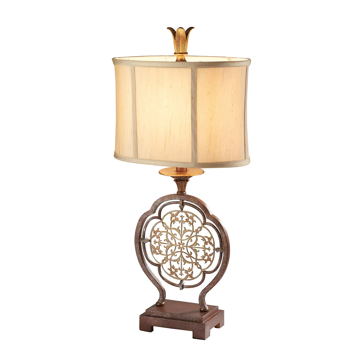 Introducing the Marcella 1 Light Table Lamp - Bronze, featuring a beige rectangular faux silk shade and an ornate metal base. The intricate filigree details form a circular pattern on the base, complemented by a delicate leaf-shaped finial.