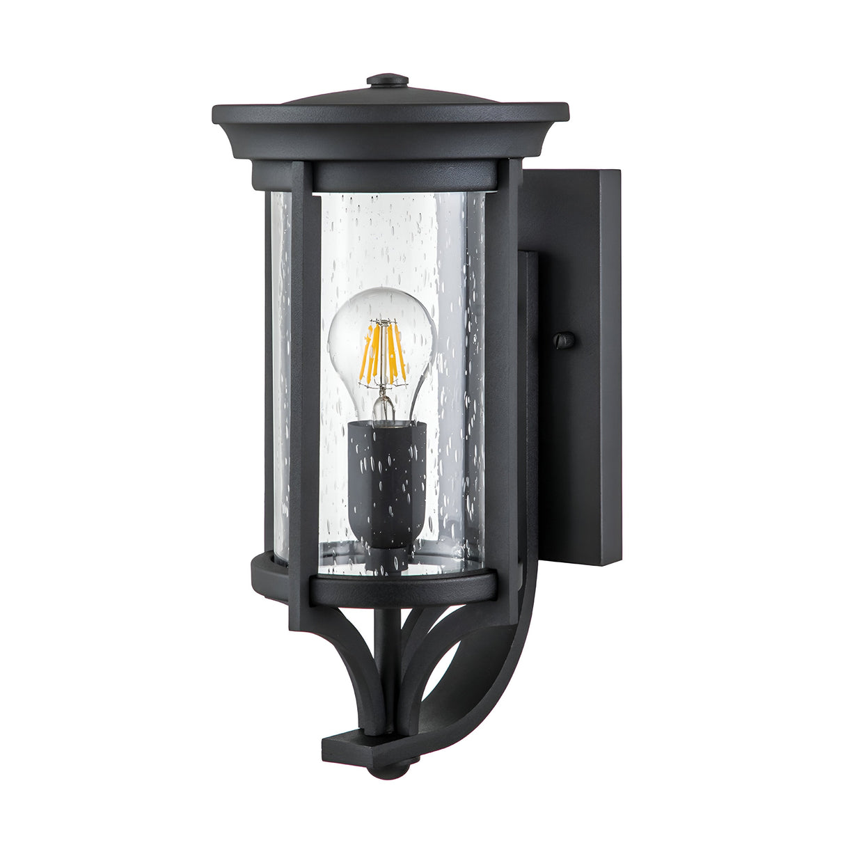 The Merrill 1 Light Small Outdoor Wall Lantern - Black is a stylish outdoor fixture with a black cylindrical metal frame and clear, seeded glass. Inside, it showcases a bright visible LED bulb, while the design features an elegant decorative curved support at the base for added sophistication.