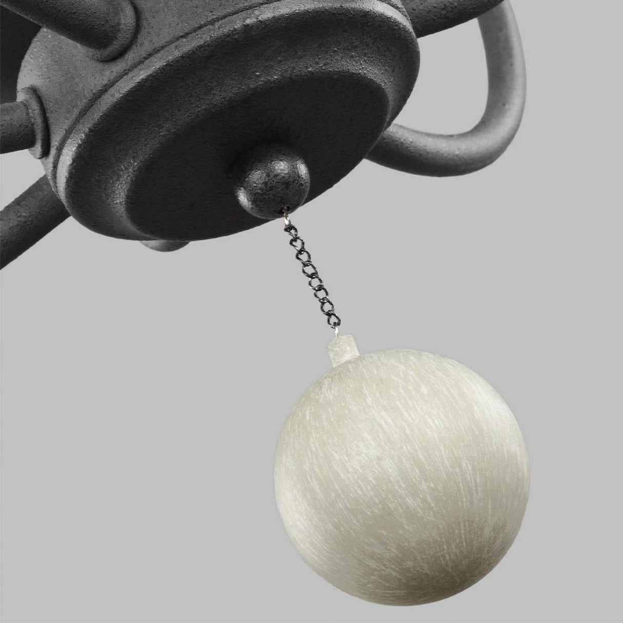 The Nori 6 Light Chandelier in Dark Weathered Zinc with Driftwood Grey features a black ceiling fixture, similar to the mentioned design, suspending a small white pendulum on a short chain against a simple gray background.