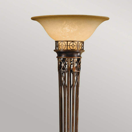 The Opera 1 Light Torchiere in Firenze Gold features an elegant wide amber glass shade and an intricately designed metal base with geometric patterns and ornate detailing, offering a traditional design with a classic, artistic flair.