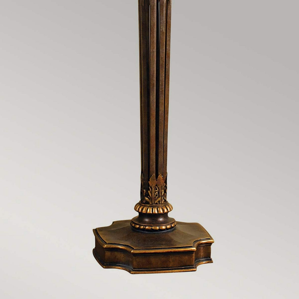 A tall and ornate Opera 1 Light Torchiere, finished in Firenze Gold, features decorative detailing on a beautifully designed square base. It stands against a plain gray background.