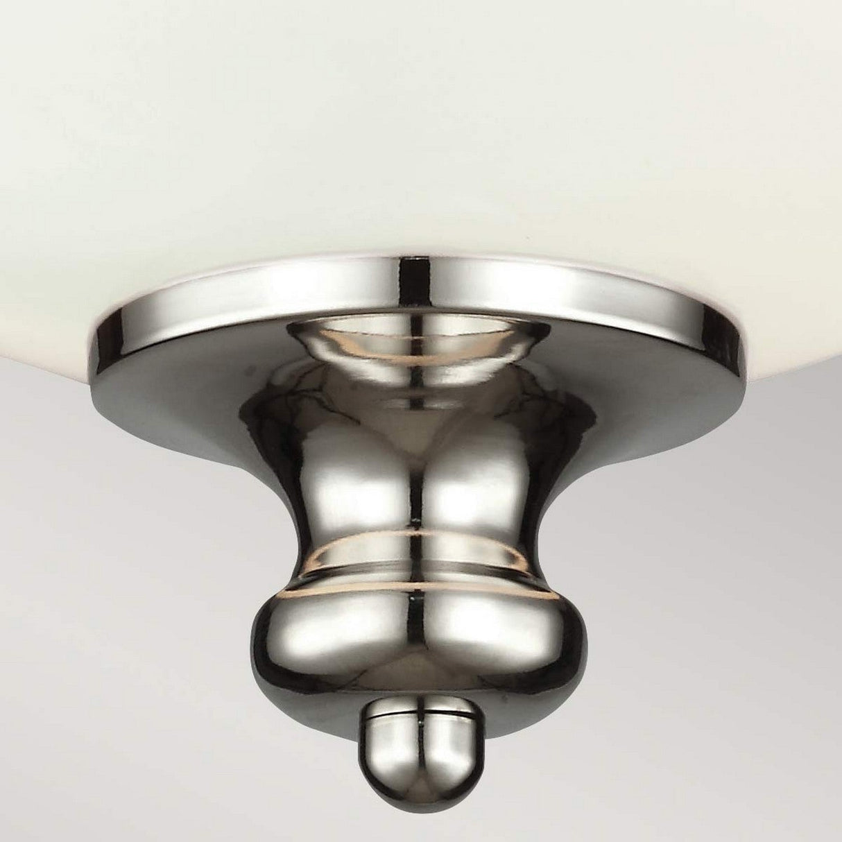Close-up of the Parkman 2 Light Flush - Polished Nickel on a white ceiling. This fixture showcases a minimalist design with a smooth, reflective metallic finish and a symmetrical, bulbous shape.