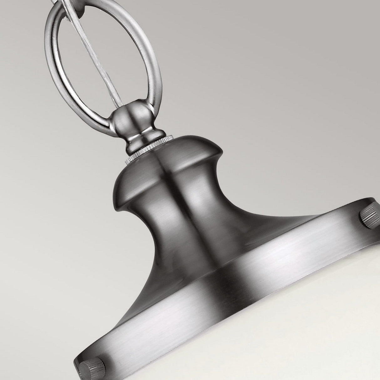 Close-up of the Parkman 1 Light Large Pendant in polished nickel, featuring a sleek design with a rounded top and circular connector. The pendant is complemented by a smooth, light-colored glass shade that embodies modern interior styles.