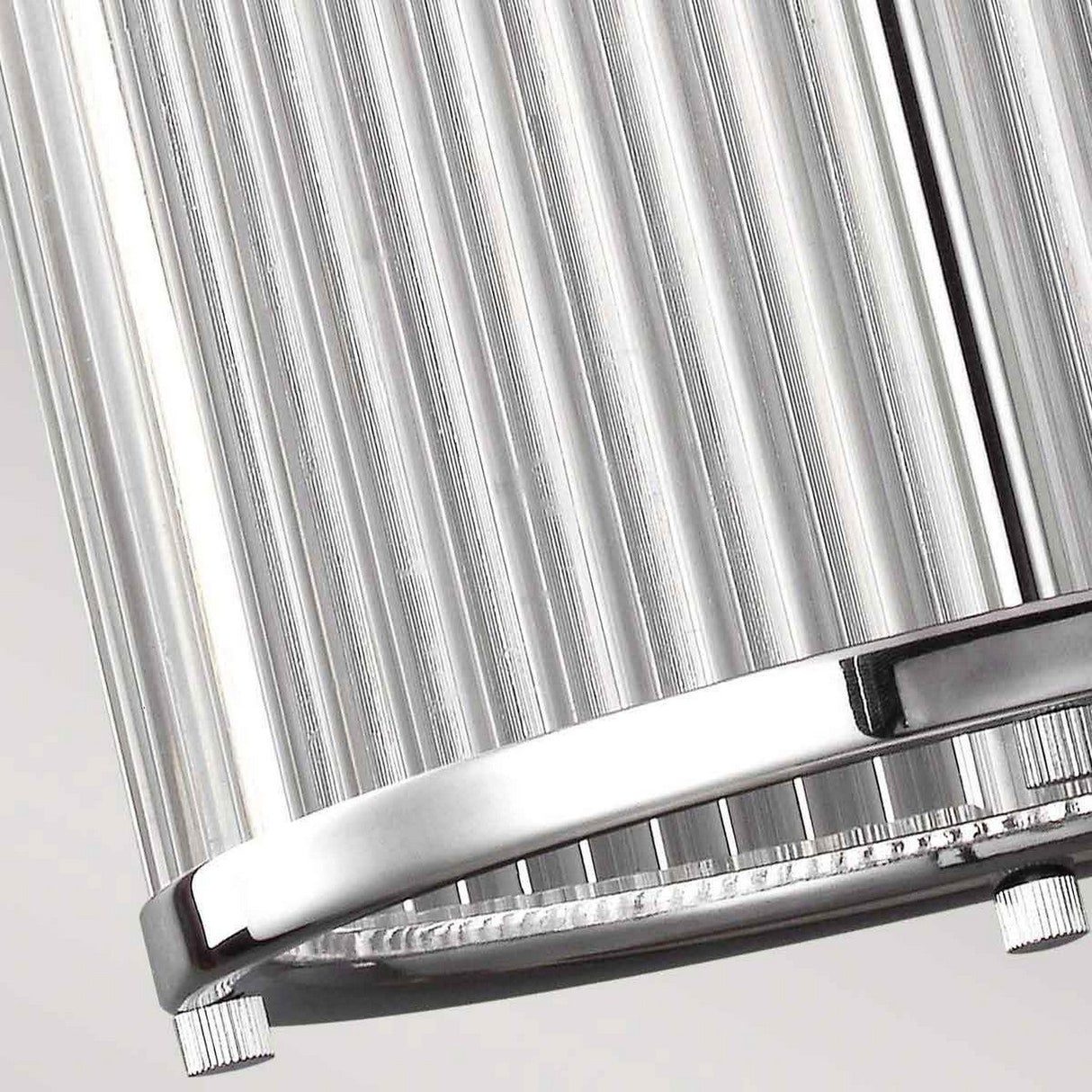 Close-up of the Paulson 3 Light Pendant - Chrome, featuring vertical ribbed grooves and a shiny chrome finish, set against a light gray background.